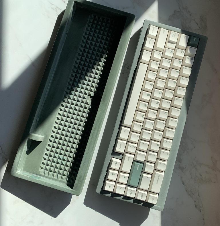 Titus65 (IC) - Keyboard interest check cover image featuring Titus65, Mehka Studio, 65% mechanical keyboard, concrete keyboard, gummy O-ring mount, Bakeneko65 compatible, Array Parallel PCB, unique keyboard design, brutalist architecture keyboard, Roman architecture keyboard