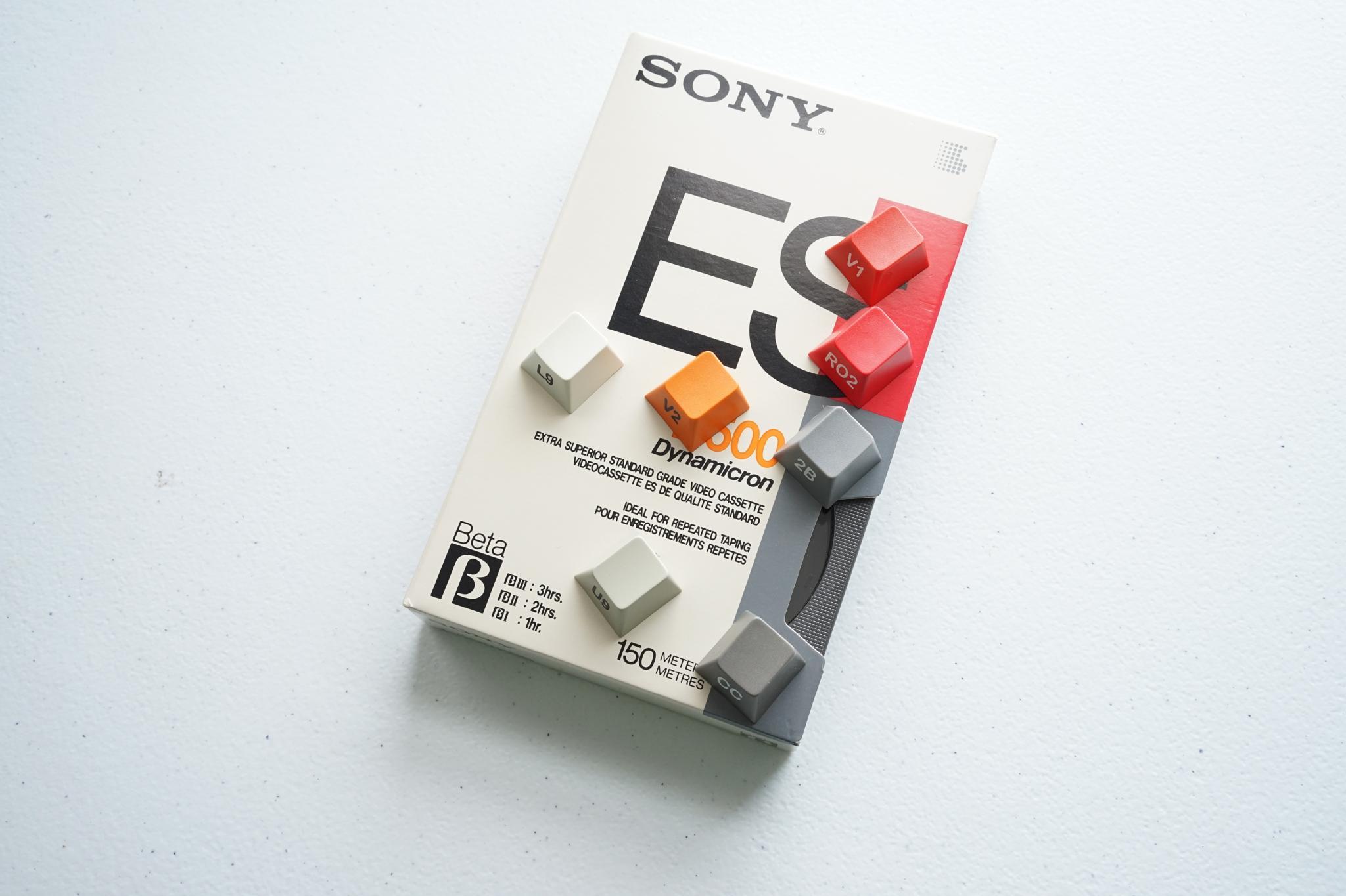 GMK βeta (GB) - Keycap group buy cover image featuring GMK Beta, keyset, group buy, Krelbit, Switchmod.net, Oblotzky, RAMA WORKS, Betamax, keycaps, Hiragana sublegends, spacebars