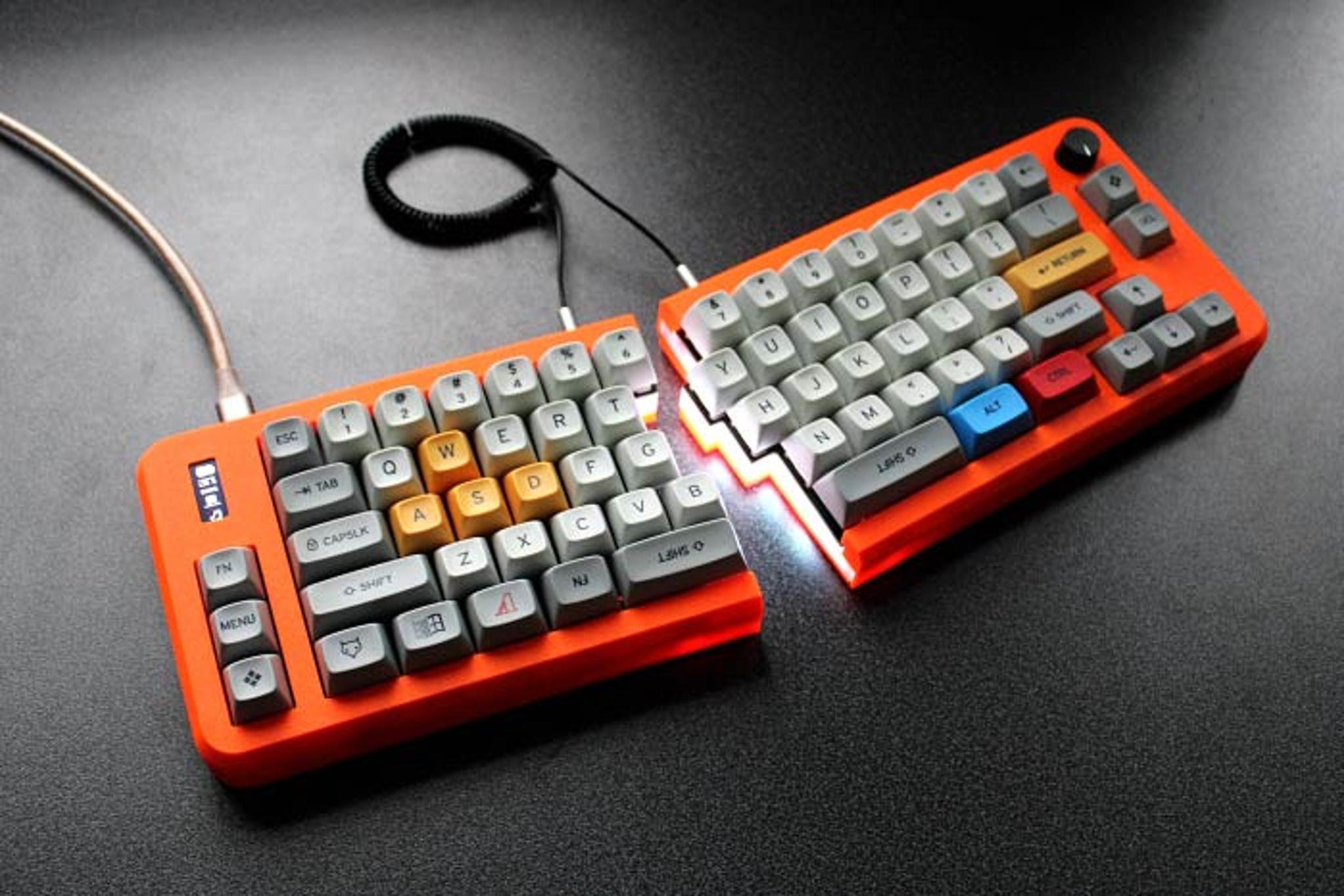 UM-70 (IC) - Keyboard interest check cover image featuring UM-70, split keyboard, 70 keys, 65% layout, OLED screen, RGB lighting, USB-C, QMK, VIA, 3D printed, macro keys